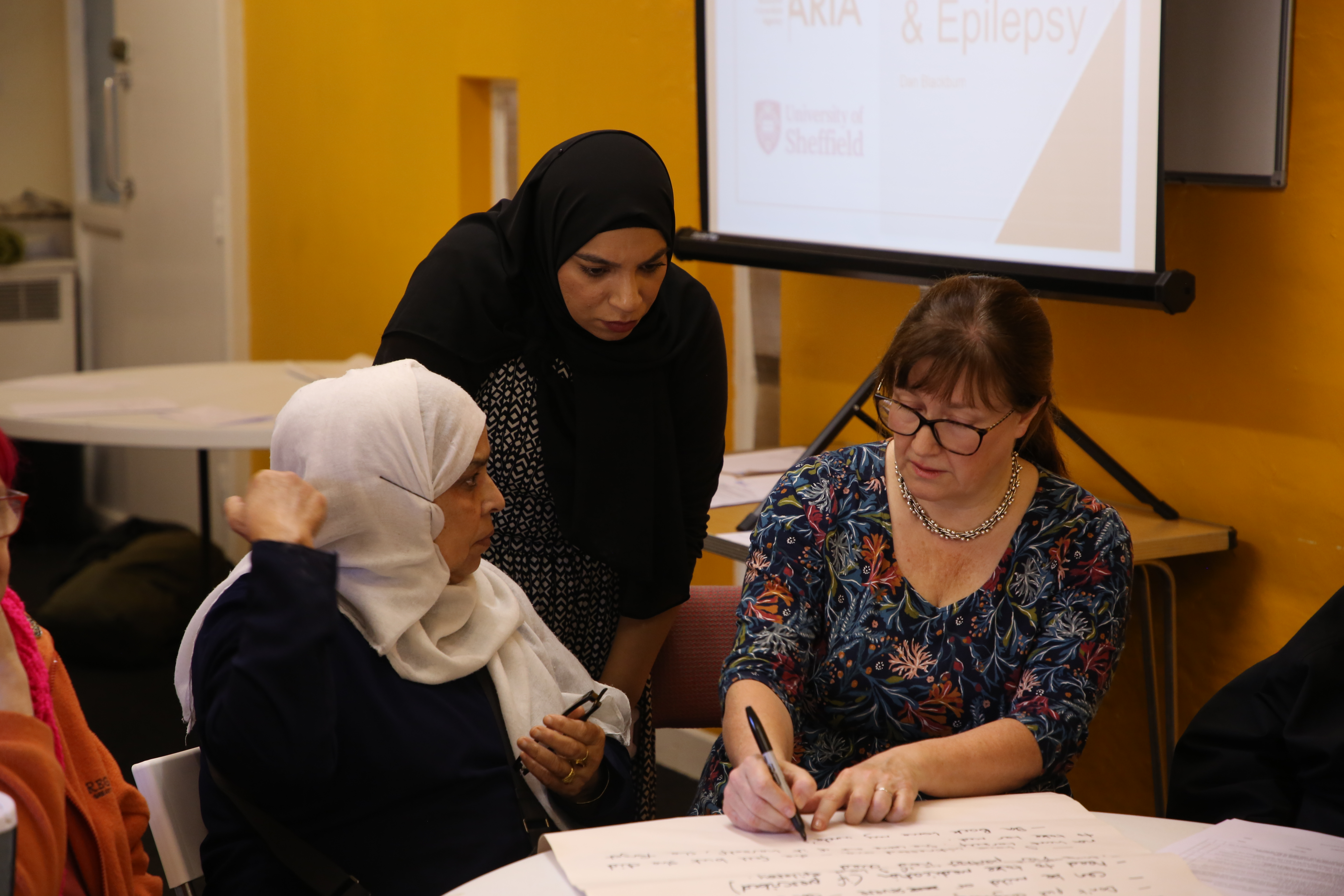 Community members in conversation at an Israac workshop